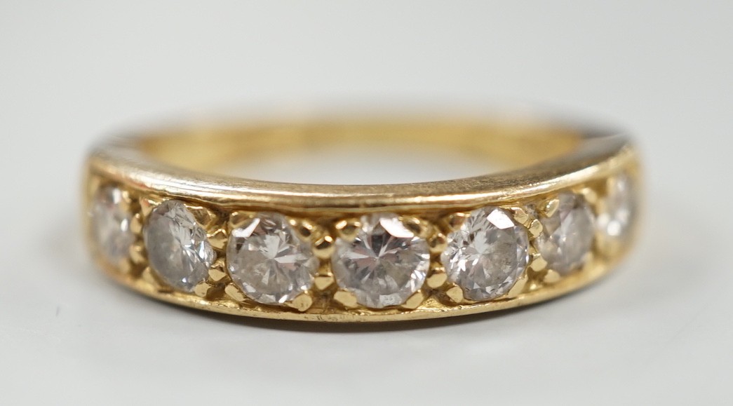 A modern 18ct gold and seven stone diamond set half hoop ring, size P, gross weight 5.3 grams.